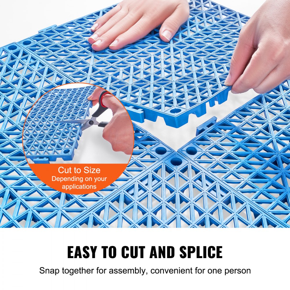 Hands cutting and assembling blue interlocking PVC drainage floor tiles.