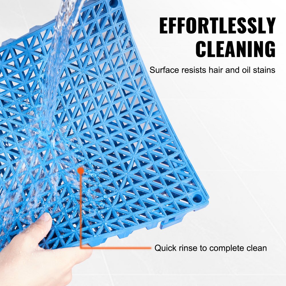 Blue PVC interlocking drainage floor tile with water rinsing off its surface.