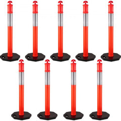 Nine orange 44-inch traffic delineator posts with reflective bands and weighted rubber bases.