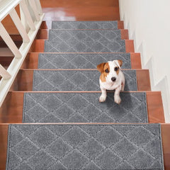 Gray non-slip stair treads installed on wooden steps with a Jack Russell terrier sitting on one.