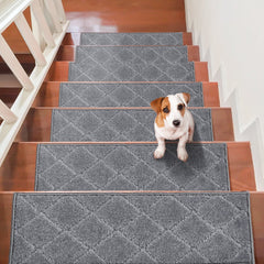 Gray non-slip stair treads installed on wooden steps with a Jack Russell terrier sitting on one.