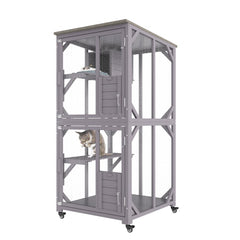 A tall, gray, three-tier wooden cat house with mesh sides and two cats inside.
