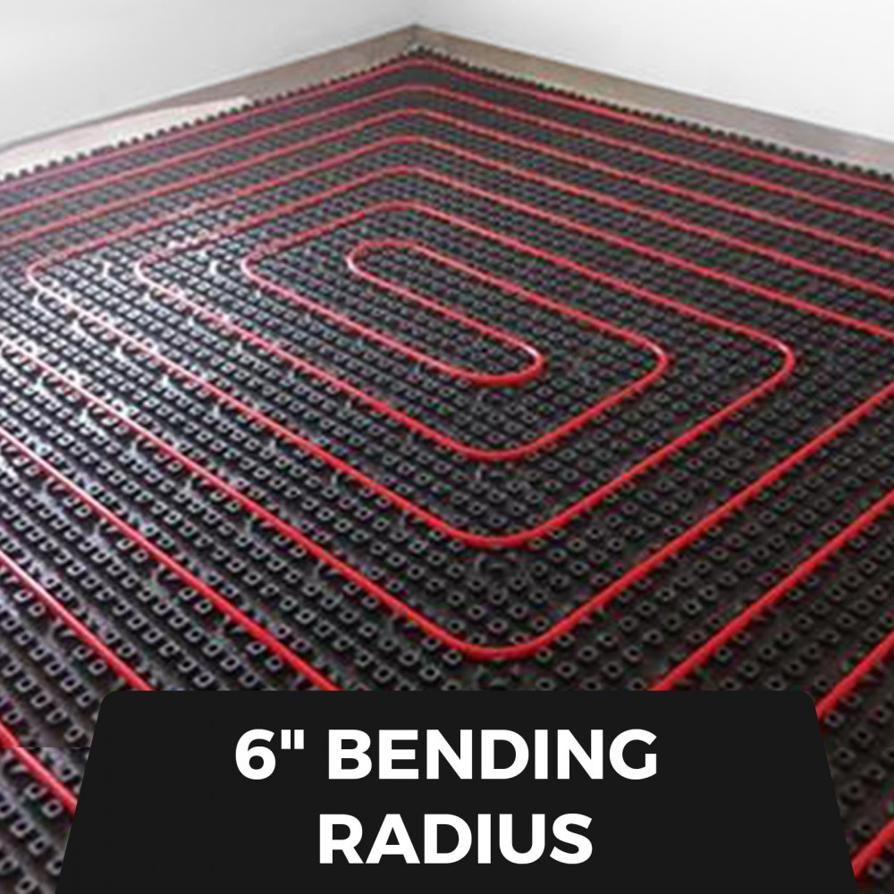 Close-up of red PEX tubing coil with 6-inch bending radius on black mat.