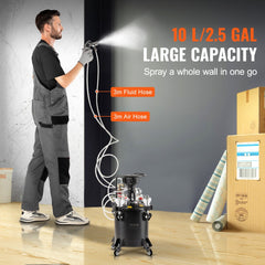 A man uses a black 10L spray paint pressure pot with 3m fluid and air hoses to paint a wall.