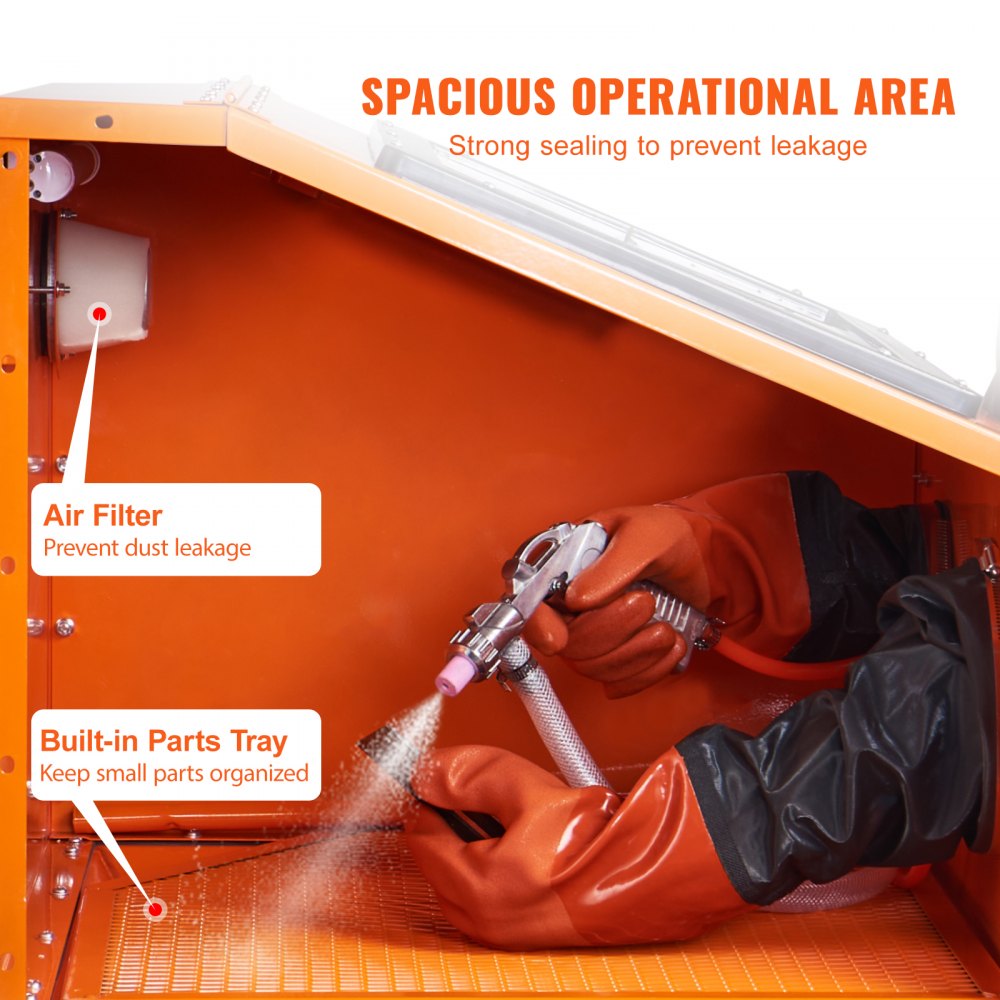 Orange steel sandblasting cabinet with air filter, parts tray, and gloved hand using spray gun inside.