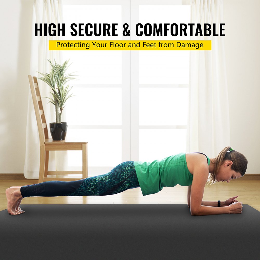 A woman performs a plank on a grey and black non-slip PVC dance floor roll in a living room.