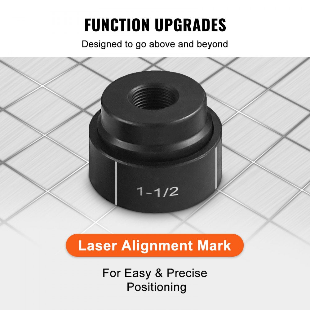 Close-up of black 1-1/2 inch knockout punch die with laser alignment mark on grid surface.