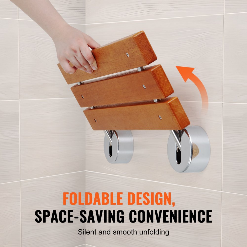 A hand unfolds a wall-mounted wooden folding shower seat in a tiled bathroom.