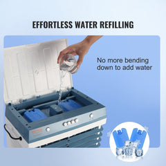 Hand pouring water into the top hatch of a blue Bostome portable evaporative swamp cooler with ice packs.