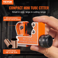 Compact orange mini tubing cutter with SKD steel blade for 1/8" to 1-1/8" pipes, held in hand.
