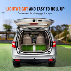 Green 10x3 ft softball pitching mat rolled up inside an open car trunk for storage.