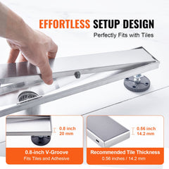 A hand installs a 36-inch brushed stainless steel linear shower drain with tile insert and V-groove on a surface.