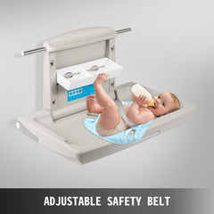 Gray HDPE wall-mounted baby changing station with adjustable safety belt and integrated storage.