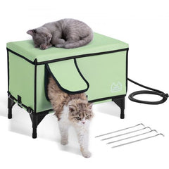 Green waterproof elevated heated cat house with insulated interior and private door curtain.