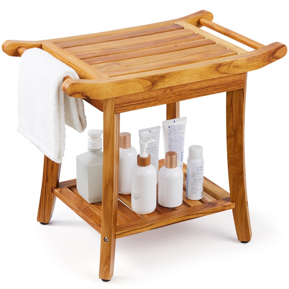 Wooden teak shower bench with slatted seat, shelf holding toiletries, draped towel, and side handles.